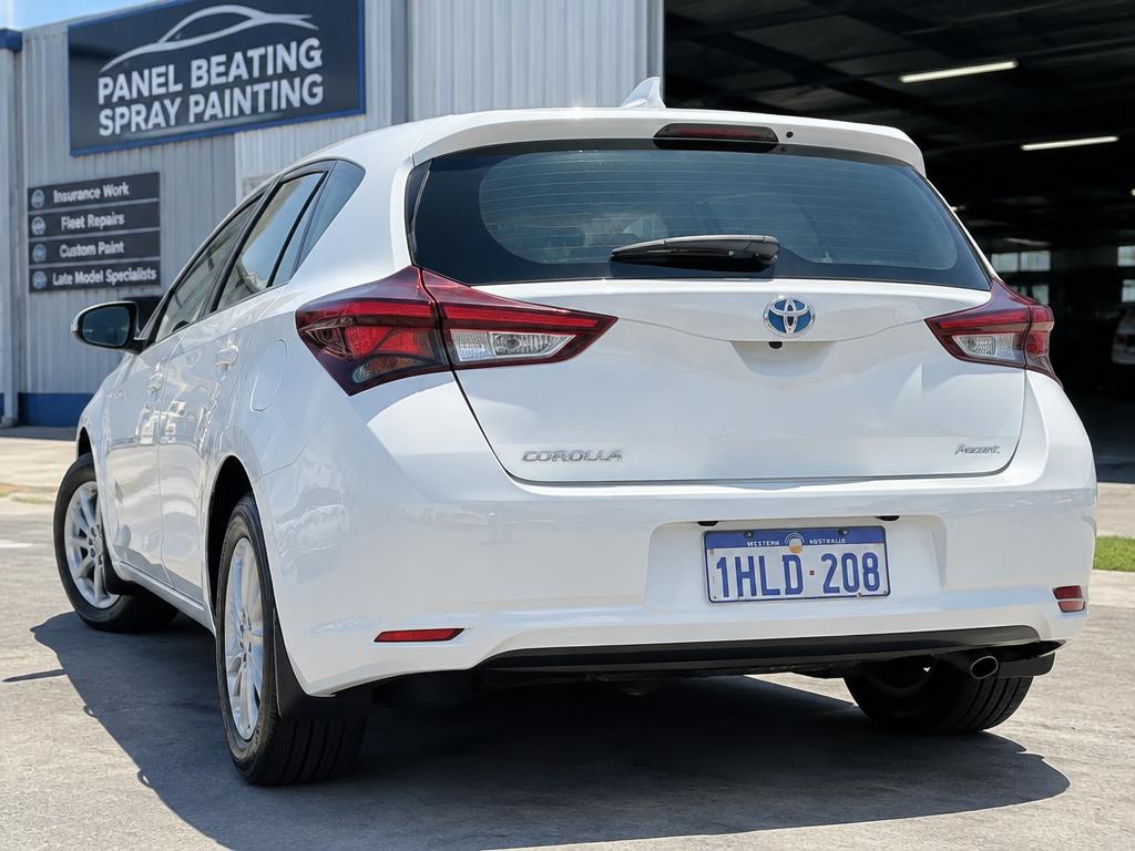 White hatchback with a freshly repaired and resprayed rear bumper